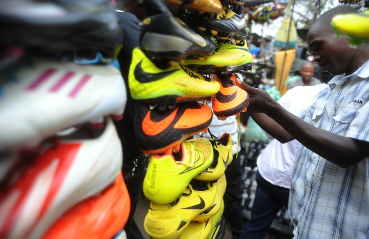 A shopper looks at football shoes displayed in Gikomba Market, East Africa's biggest secondhand clothing market, on July 10, 2014, in Nairobi, Kenya.