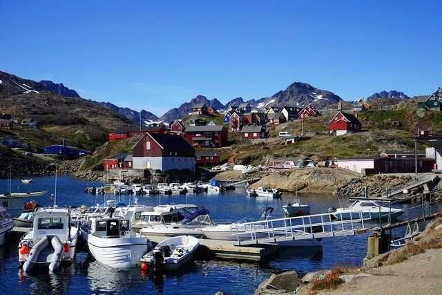 Fishing boats tied up at a port in Greenland.