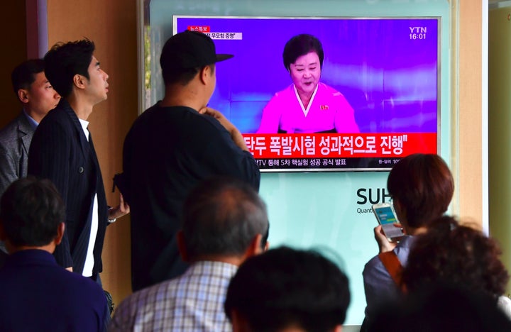 People watch a television news broadcast showing a North Korean anchor announcing the country's latest nuclear test carried out on Friday in defiance of U.N. sanctions.