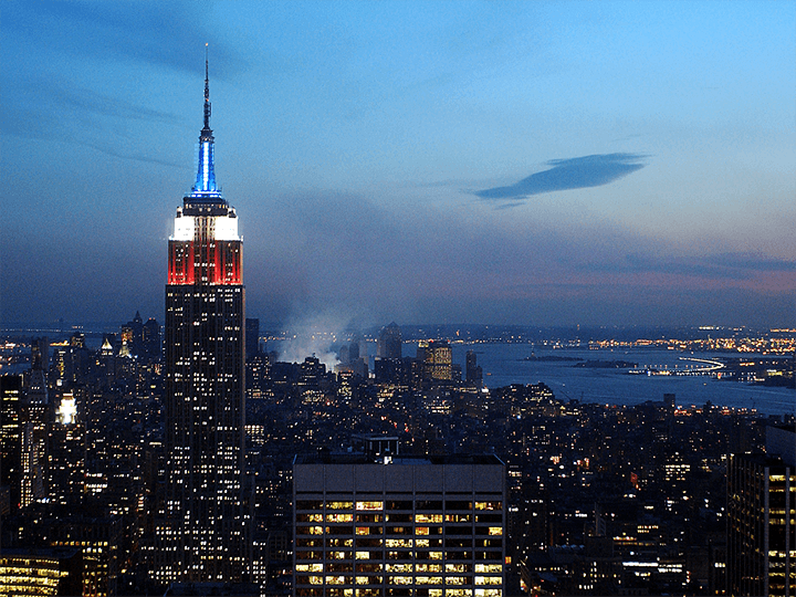 An unfamiliar skyline: Just two days after the Twin Towers collapsed, Ground Zero remained illuminated, as the Empire State Building was lit in red, white, and blue lights.