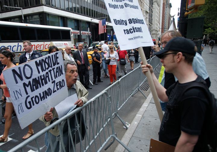 Anti-mosque supporter Lenny Nor, left, exchanges words with James Owens as he walks past supporters of a pro-Muslim rally near the proposed site of a mosque during ceremonies marking the 10th anniversary of the 9/11 attacks in New York City.