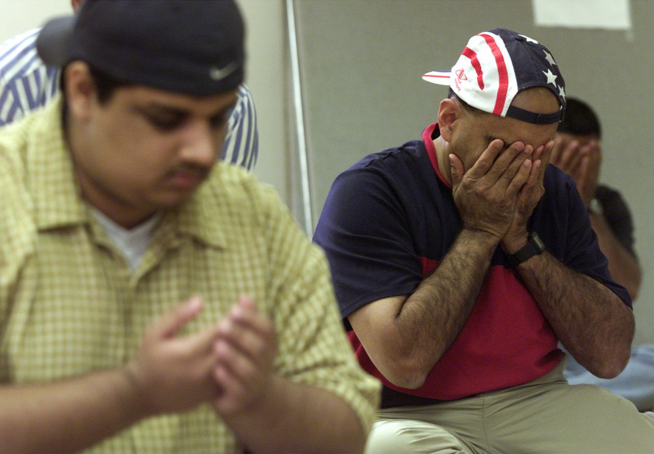 Safdar Khwaja, right, of Murraysville, Pennsylvania, takes part in a prayer service for victims of the Sept. 11 terrorist attacks, held by the Muslim Community of Greater Pittsburgh in Monroeville, Pennsylvania, on Sept. 14, 2001.