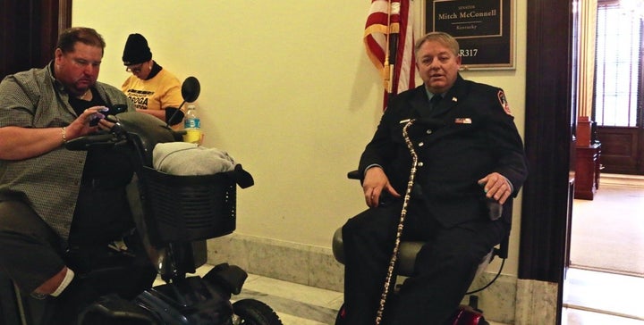 Kenny Anderson and Ray Pfeifer wait outside Mitch McConnell's office hoping to plead for his help passing a new 9/11 bill.