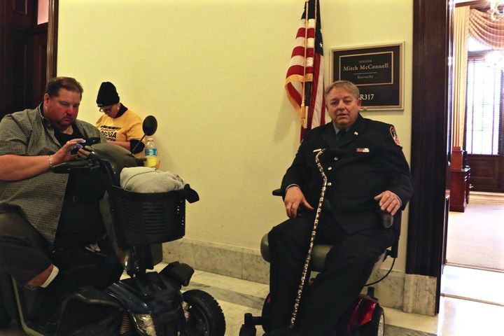 Kenny Anderson and Ray Pfeifer wait outside Mitch McConnell's office hoping to plead for his help passing a new 9/11 bill.