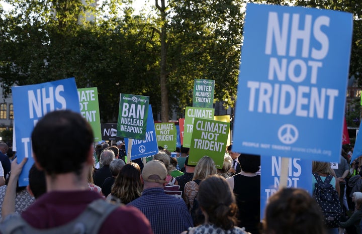 Demonstrators calling for government funds to be spent on the NHS and climate change in central London on July 18.