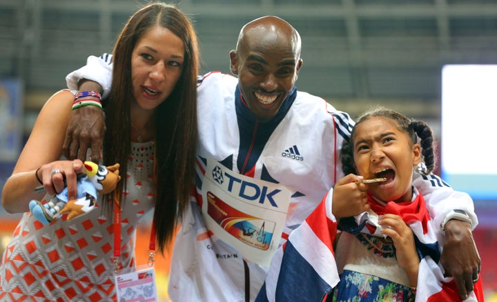 Great Britain's Mo Farah poses with his wife Tania and daughter Rihanna after winning the Men's 5000 metres in Rio.