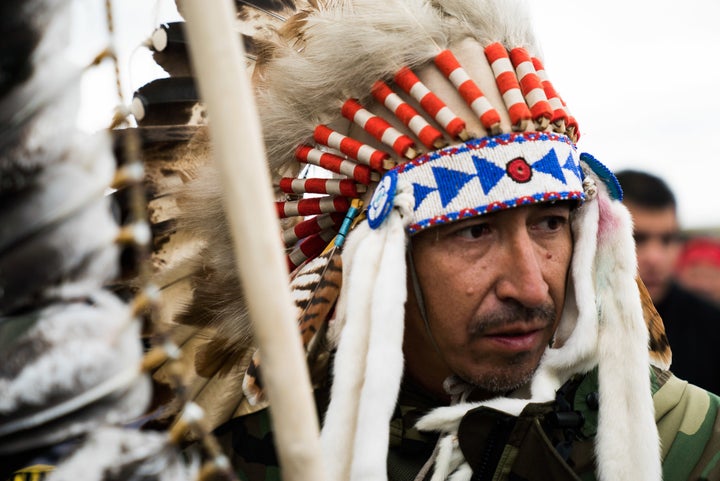 A man wears a feather-adorned headdress during a protest in Cannon Ball, North Dakota.