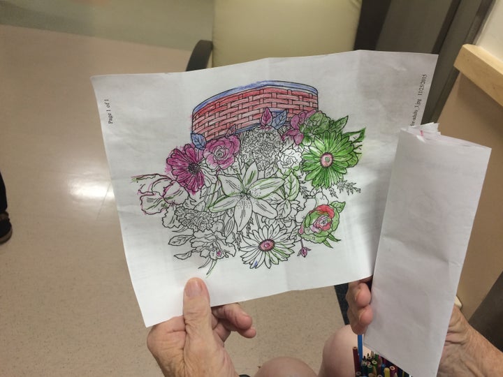 Here is a patient showing me one of his many colored pictures — note the cup full of pencils in the bottom right. ‘Classic co