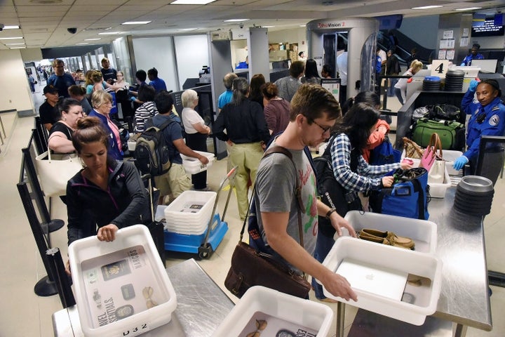 Delayed passengers inside Terminal 7 at Los Angeles International Airport line up to go through TSA security check following a false alarm event in Los Angeles, California, Aug. 28, 2016.