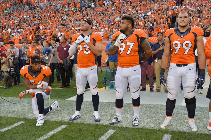 Denver Broncos inside linebacker Brandon Marshall kneels during the national anthem.