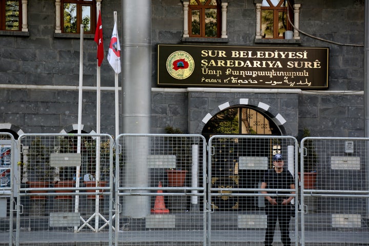 A riot police officer stands guard in front of Sur municipality office, following the removal of the local mayor from office after he was deemed to support Kurdish militants, in Diyarbakir, Turkey, September 11, 2016