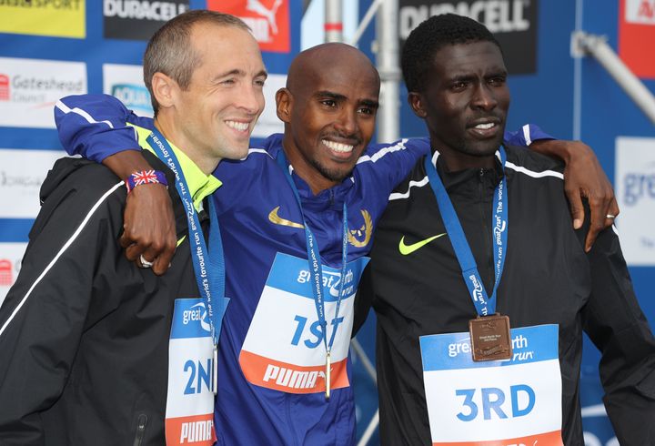 Mo Farah celebrates winning the Great North Run on Sunday with runner-up, US runner Dathan Ritzenhein (L) and third place runner, Kenya's Emmanuel Bett.