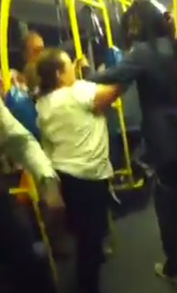 The pair exchange blows before the man shoves the woman out of the bus door