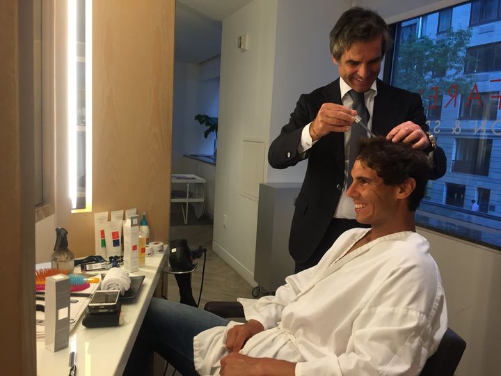 Julien Farel trimming Rafael Nadal's hair. 