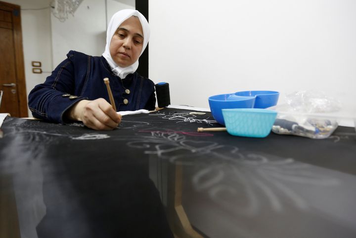 Rana, a Syrian refugee, works on a handmade loom under Jasmine, a project which hires and trains Syrian refugee women to create handicrafts, in Amman, Jordan, July 11, 2016. REUTERS/Muhammad Hamed