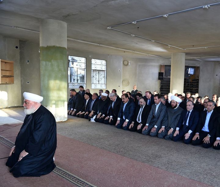 Syria's Bashar Assad prays at a mosque in the Damascus suburb of Daraya in this handout picture provided by the Syrian official news agency SANA on Sept. 12, 2016.