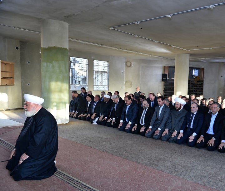 Syria's Bashar Assad prays at a mosque in the Damascus suburb of Daraya in this handout picture provided by the Syrian official news agency SANA on Sept. 12, 2016.