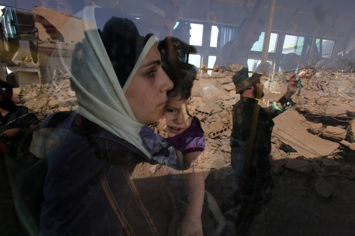 A woman and child are evacuated from Daraya by bus on Aug. 26, 2016, as part of a deal between the Syrian forc
