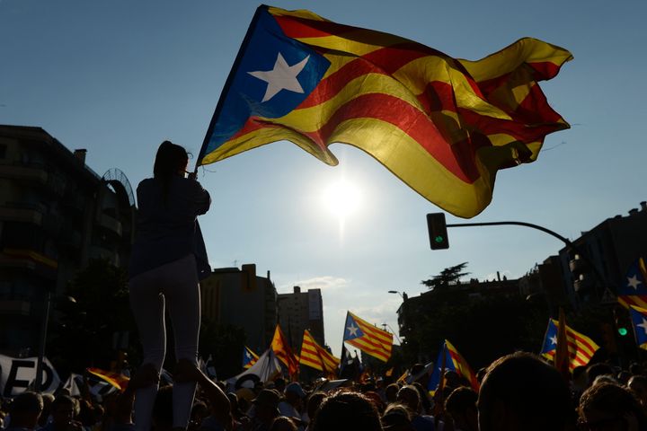 People wave 'Estaladas' (pro-independence Catalan flags) as they gather during a pro-independence demonstration, on September 11, 2016.