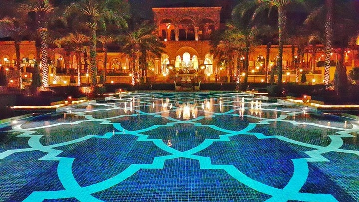 The hotel pool beautifully lit at night