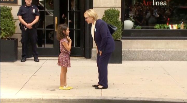 Democratic presidential nominee Hillary Clinton greets a girl on the sidewalk after leaving her daughter Chelsea's home in New York, September 11, 2016 in this still image taken from video.