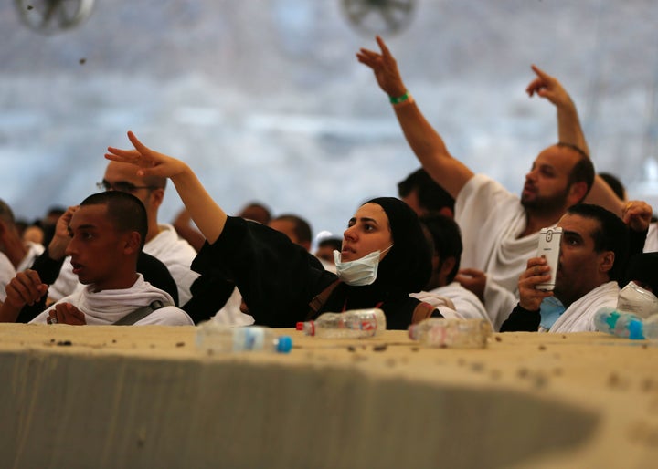 Muslim pilgrims throw pebbles at pillars during the 'Jamarat' ritual, the stoning of Satan, in Mina near the holy city of Mec