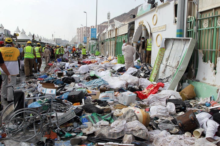 Saudi emergency personnel stand near bodies of hajj pilgrims at the site where hundreds were killed in a stampede in Mina on