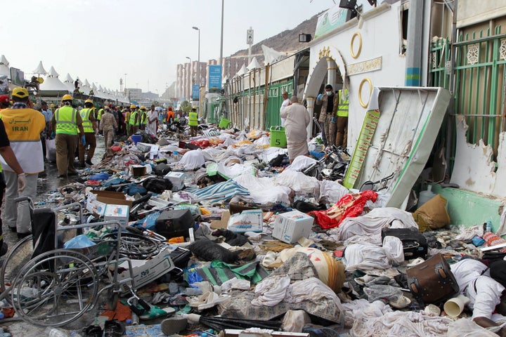 Saudi emergency personnel stand near bodies of hajj pilgrims at the site where hundreds were killed in a stampede in Mina on September 24, 2015.