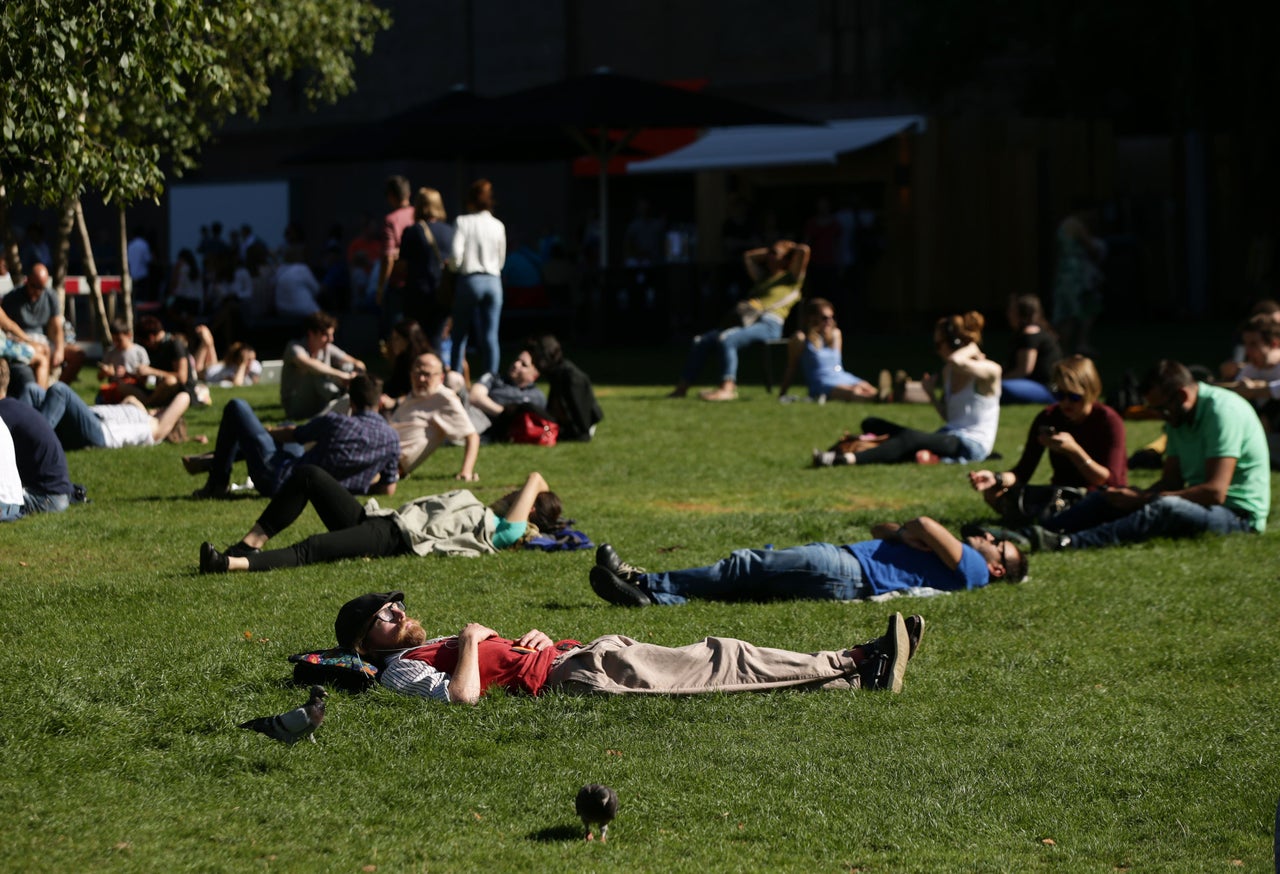 People enjoy the weather at Bankside, London, at the weekend