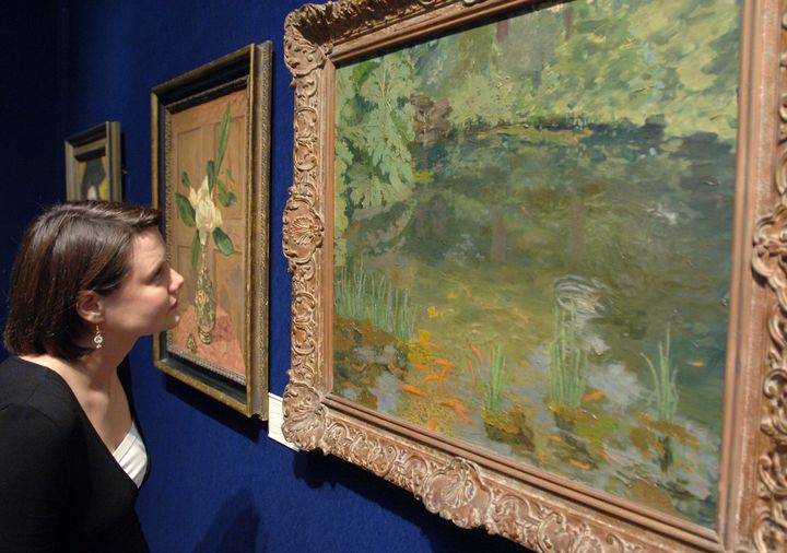 Christies employee Emma Cunningham inspects the Goldfish Pool at Chartwell.