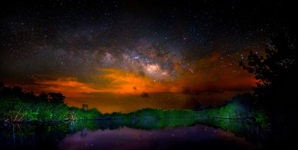 Brush fires in Everglades National Park make for a dramatic Milky Way in this panorama.