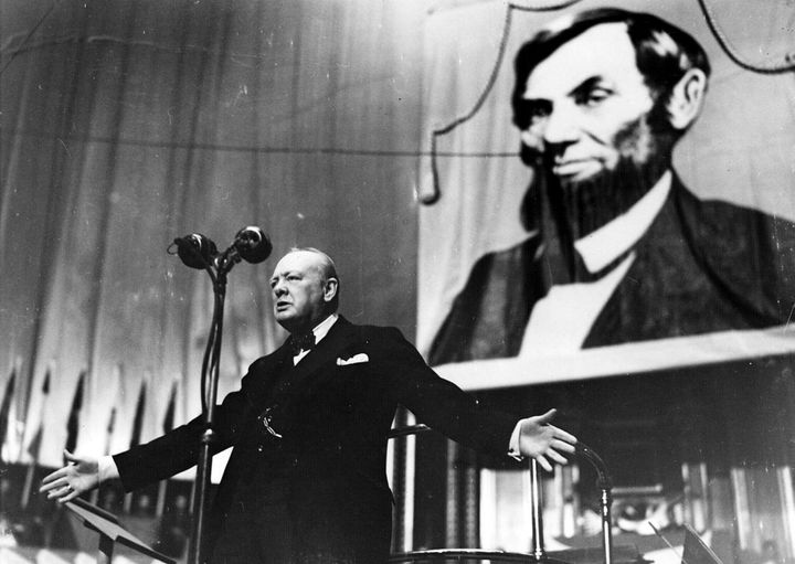 Speaking at the Albert Hall in front of a large picture of Abraham Lincoln in 1944.