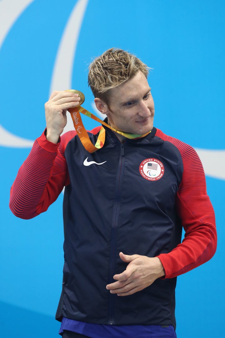 Gold medalist Bradley Snyder of the United States rattles his medal on the podium for the Men's 400m Freestyle.