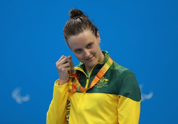 Ellie Cole of Australia holds her silver medal up to her ear on the podium at the medal ceremony for the Women's 400m Freestyle.