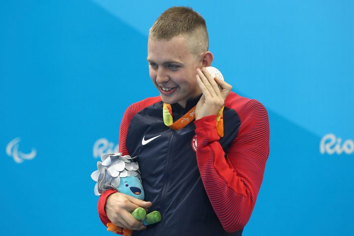 Silver medalist Tharon Drake of the United States listens to the sound of his medal on the podium at the medal ceremony for the Men's 400m Freestyle.