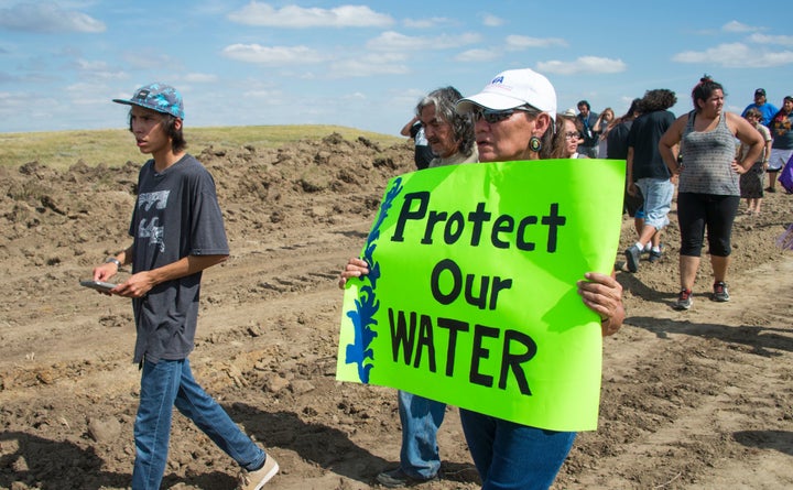 A protester of the Dakota Access Pipeline (DAPL) holds a sign at a demonstration in Cannon Ball, North Dakota, on Sept. 3.