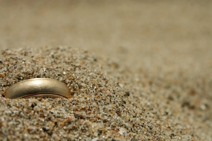 A gold ring lost in the sand.