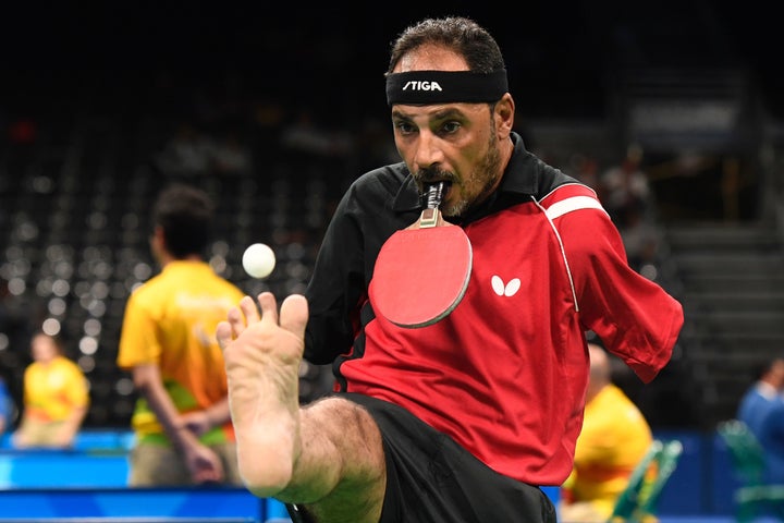 <strong>Egypt's Ibrahim Hamadtou holds his paddle in his mouth</strong>