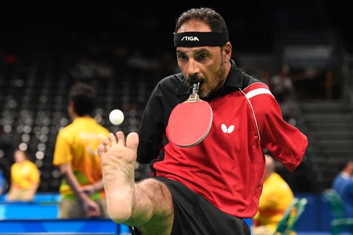 Egypt's Ibrahim Hamadtou holds his paddle in his mouth