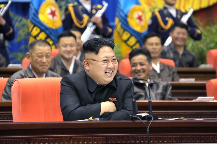 <strong>Kim Jong-un laughing with members of his military.</strong>