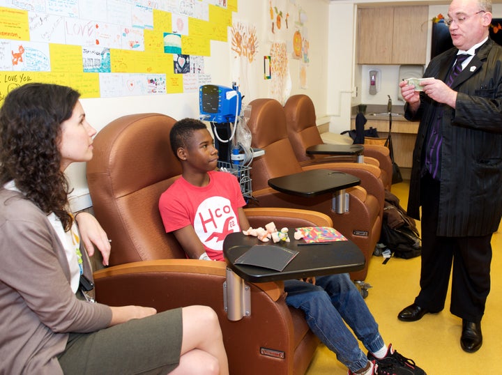 Social Worker Shannon Heffernan sits with a pediatric cancer patient during a Jay Fund Valentine's Day Party at St. Joseph's Regional Hospital.