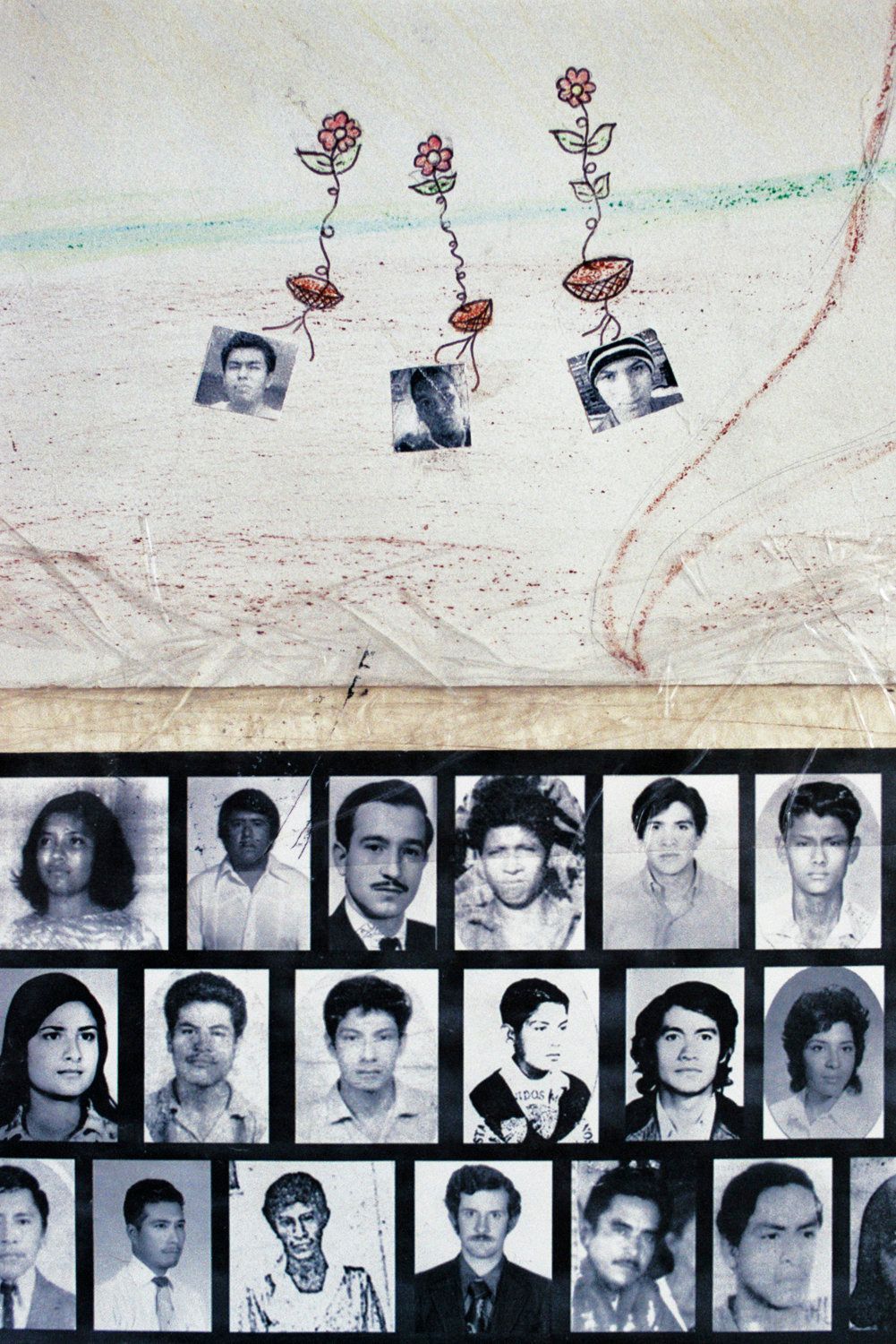 Drawings of Julio César Ramírez, Daniel Solís and Julio César Mondragón, the three Ayotzinapa students who were murdered during the Iguala attacks, on a poster at the Ayotzinapa Normal School on March 15, 2015. Below them, a poster shows images of Mexicans who disappeared during the "dirty war," a period of intense state repression, enforced disappearances and extrajudicial executions between the 1960s and the 1980s. 