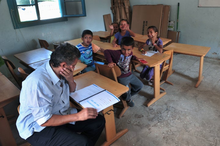 Children sit in a classroom in the refugee camp of Lagadikia, near Thessaloniki, Greece, during the visit of UN High Commissioner for Refugees Filippo Grandi on Aug. 25, 2016.