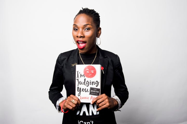 Luvvie Ajayi poses for a portrait at the HuffPost office with her new book, "I'm Judging You: The Do-Better Manual."