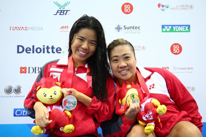 Yip Pin Xiu (left) and Theresa Goh pose after winning medals at ASEAN Para Games in 2015.