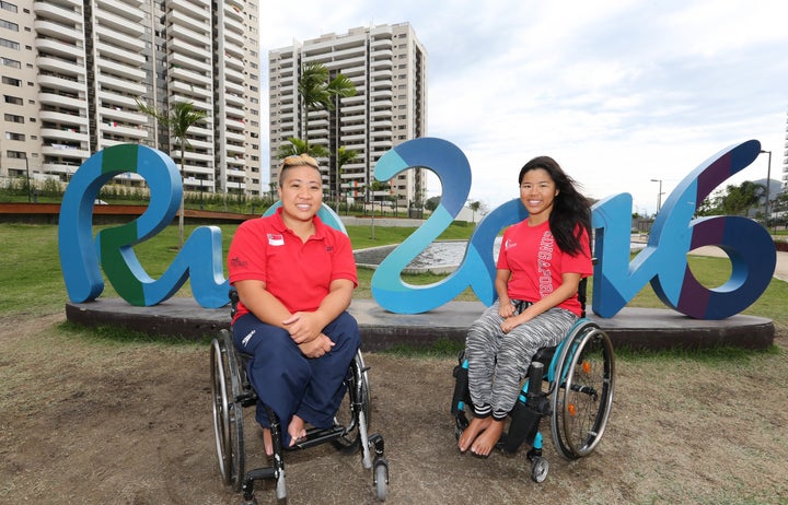 Theresa Goh and Yip Pin Xiu pose for a picture during a tour of the Paralympic village.