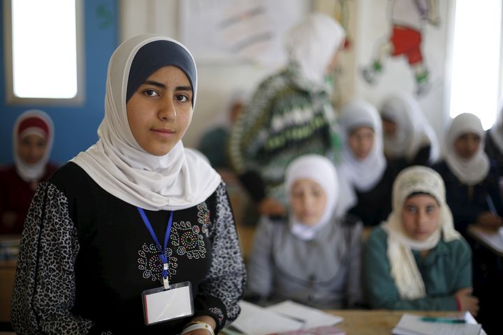 Syrian refugee Omayma al Hushan, 14, who launched an initiative against child marriage among Syrian refugees, poses as she speaks to her friends about her initiative at school in Al Zaatari refugee camp in the Jordanian city of Mafraq, near the border with Syria, April 21, 2016. REUTERS/Muhammad Hamed