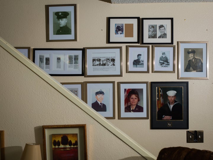 Tina Cramer Showers comes from a family of veterans. A wall in her home in Anchorage, Alaska, displays some of their photos.