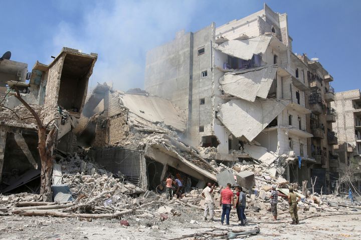 Men inspect a damaged site after double airstrikes on the rebel held Bab al-Nairab neighborhood of Aleppo, Syria, August 27, 2016.