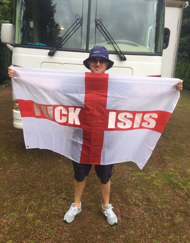 Tommy Robinson with his fuck Isis flag